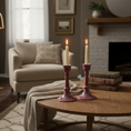Load image into Gallery viewer, Ahava Memorials handcrafted ceramic candlesticks made with ashes, glowing in candlelight as a peaceful cremation memorial centerpiece in a cozy room.