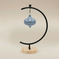Load image into Gallery viewer, (ice)
Handcrafted ice-blue ceramic curvy retro ornament made with ashes, a peaceful cremation keepsake by Ahava Memorials.