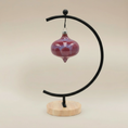 Load image into Gallery viewer, (sunstone-red)
Sunstone red ceramic curvy retro ornament made with ashes, handcrafted by Ahava Memorials to represent love, strength, and devotion.