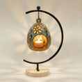 Load image into Gallery viewer, (jasper gold)
Jasper gold ceramic floral luminary made with ashes, a luminous handcrafted cremation memorial by Ahava Memorials with a candle glowing through floral openings.