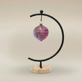 Load image into Gallery viewer, (sunstone red)
Sunstone red ceramic wave ornament made with ashes, handcrafted by Ahava Memorials to represent love, strength, and enduring memory.