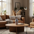 Load image into Gallery viewer, Cozy living room with brown sofa, wooden coffee table, and decorative elements.