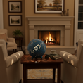 Load image into Gallery viewer, Dragonfly Luminary light by Ahava Memorials. Living room with a fireplace, chairs, and a decorative blue lamp.