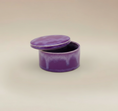 Load image into Gallery viewer, (lavender)
Lavender round ceramic box urn by Ahava Memorials, handcrafted with ashes and displayed open as an elegant memorial piece.