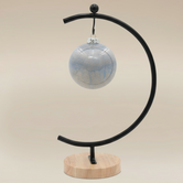 (ice)
Handcrafted ice-blue ceramic ball ornament made with ashes, a peaceful cremation keepsake by Ahava Memorials.