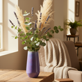 Load image into Gallery viewer, Collection of Ahava Memorials bouquet vases in multiple glaze colors, handcrafted with ashes and displayed together in a bright living room as modern memorial art.
