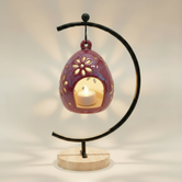 (sunstone red)
Sunstone red ceramic floral luminary made with ashes, handcrafted by Ahava Memorials and glowing warmly through star and petal cutouts with a candle inside.
