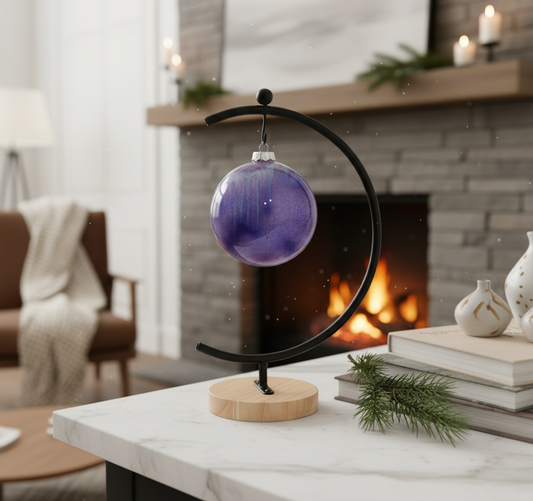 Ceramic ball ornament by Ahava Memorials, handcrafted with ashes and illuminated by natural light in a tranquil home space, representing serenity and remembrance.
