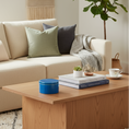 Load image into Gallery viewer, Ahava Memorials handcrafted round ceramic box urn made with ashes, displayed on a softly lit table with flowers and candles as a peaceful cremation memorial.
