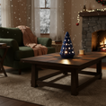 Load image into Gallery viewer, Ahava Memorials handcrafted ceramic Starlight Tree made with ashes, glowing softly in a darkened room as star-shaped lights shine through the surface.
