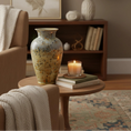 Load image into Gallery viewer, Gloria Vase in jasper gold by Ahava Memorials — handcrafted ceramic cremation memorial made with ashes, shown in a bright, elegant interior as a timeless tribute and piece of memorial art.
