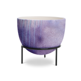 (lavender)
Purple ceramic planter with a black metal stand on a white background
