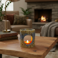 Load image into Gallery viewer, Ceramic candle holder with a lit candle on a wooden table in a cozy living room.
