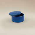 Load image into Gallery viewer, (agate blue)
Ahava Memorials agate blue round ceramic box urn, handcrafted with ashes and displayed open as a unique memorial art piece.
