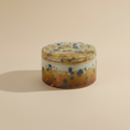 Load image into Gallery viewer, (jasper gold)
Jasper gold round ceramic box urn made with ashes, a luminous handcrafted cremation memorial by Ahava Memorials.
