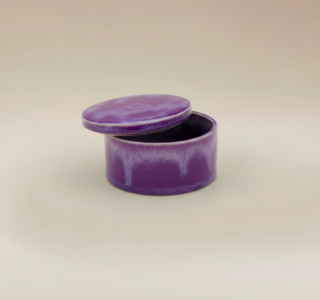 (lavender)
Lavender round ceramic box urn by Ahava Memorials, handcrafted with ashes and displayed open as an elegant memorial piece.