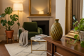 Load image into Gallery viewer, Ceramic cremation memorial vase made with ashes, handcrafted by Ahava Memorials and shown as a decorative art piece in the home.
Living room with green armchair, coffee table, and decorative items.
